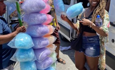 Traveler buying cotton candy at Mercado 23 local market in Cancun