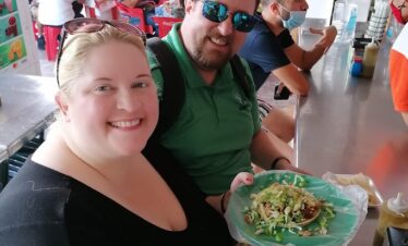 People enjoying food at market.