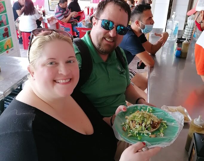People enjoying food at market.