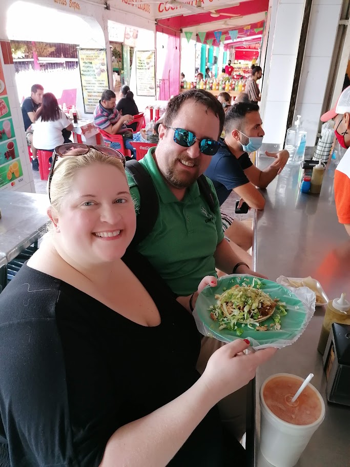 People enjoying food at market.