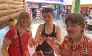 Family tasting fresh pomegranate at Mercado 23 local market in Cancun