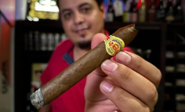 Guests enjoying cigars and Mexican spirits during a tasting experience in Cancun