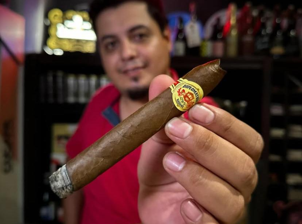 Guests enjoying cigars and Mexican spirits during a tasting experience in Cancun