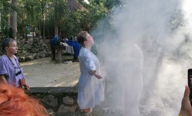 Copal smoke surrounding participant during Mayan temazcal blessing ritual