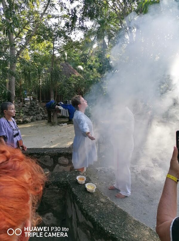 Copal smoke surrounding participant during Mayan temazcal blessing ritual