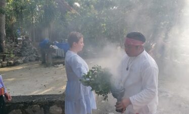 Woman receiving copal blessing before temazcal ceremony in Mayan community