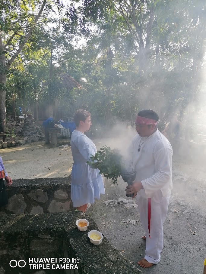 Woman receiving copal blessing before temazcal ceremony in Mayan community