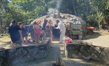 Mayan temazcal ceremony blessing at cenote entrance in Riviera Maya community