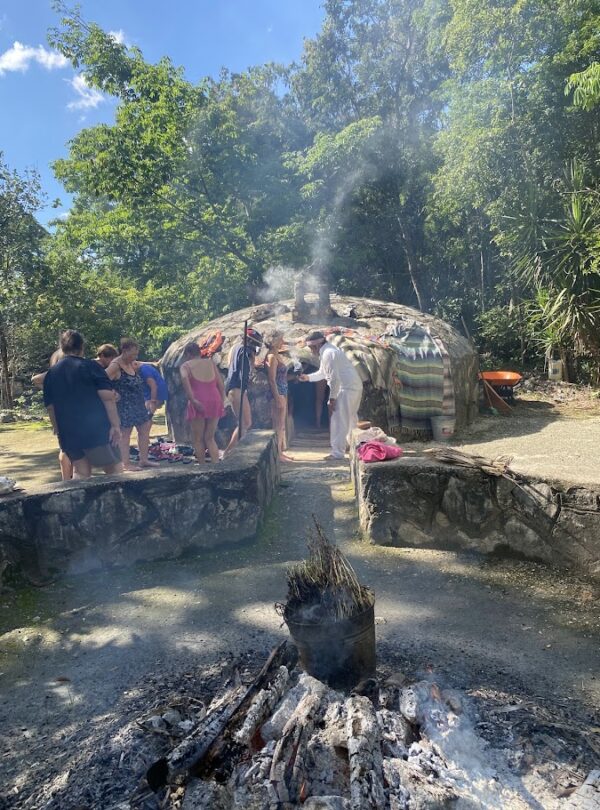 Mayan temazcal ceremony blessing at cenote entrance in Riviera Maya community