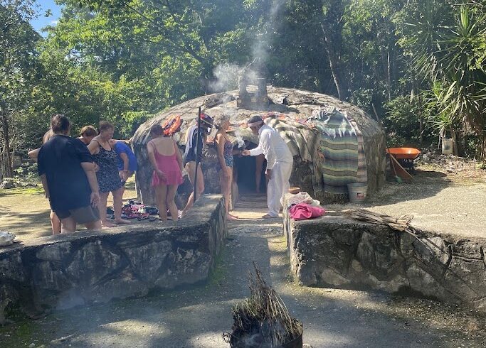 Mayan temazcal ceremony blessing at cenote entrance in Riviera Maya community
